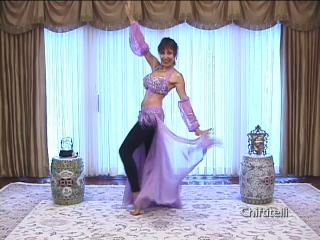 Shamira in pink costume practicing bellydance moves Shamira in pink costume practicing bellydance moves